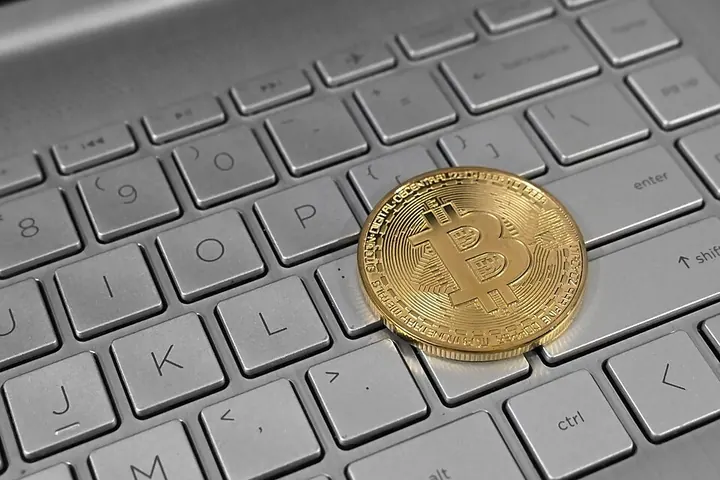 Physical bitcoin on a laptop keyboard