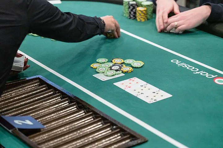 Dealer’s hands at a live card table