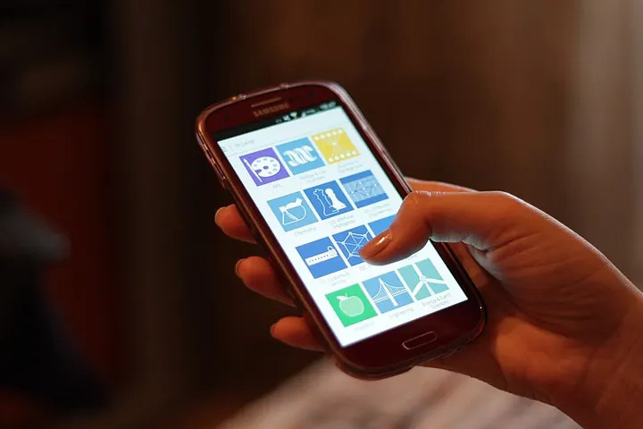 Smartphone with casino app icons in a hand